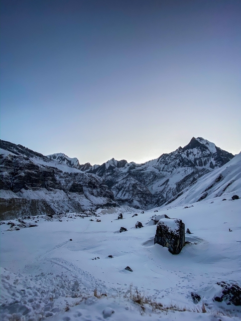       Mountain peaks with snow at twilight.
  