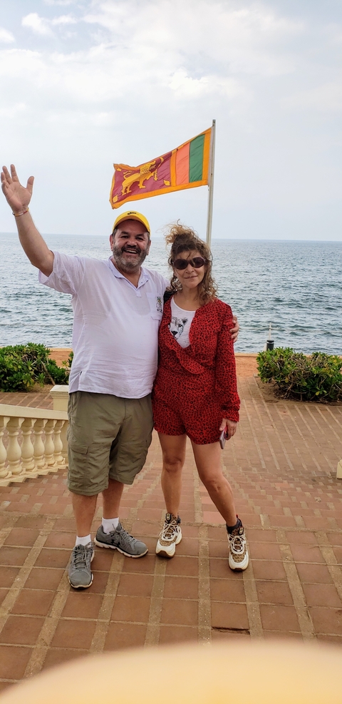       Couple posing by a waterfront.
  