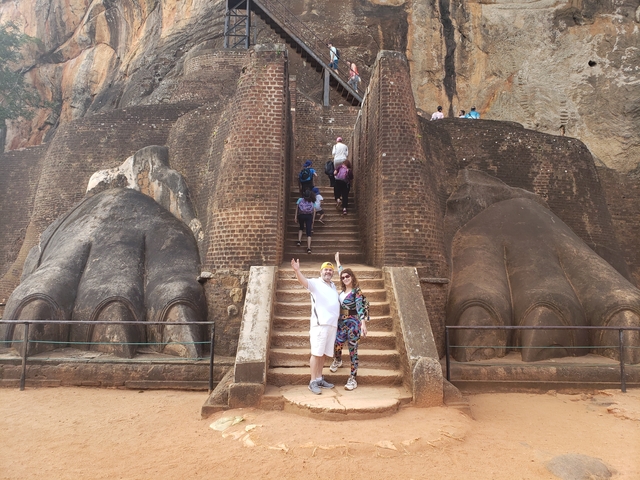       Couple posing in front of the entrance to Sigiriya.
  