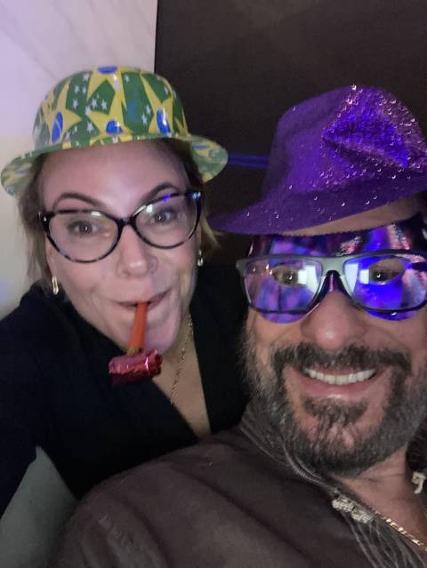 Close-up selfie of a couple wearing festive hats