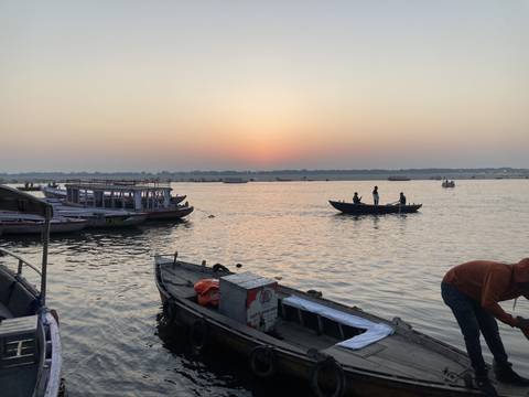 Boats on a river during sunset.