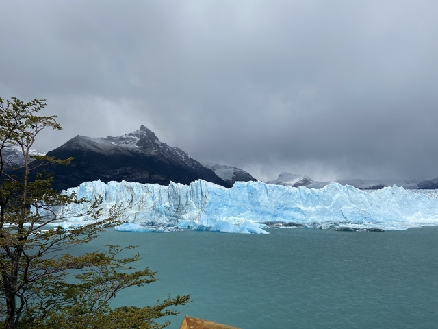       Glacial landscape with ice formations and mountains.
  