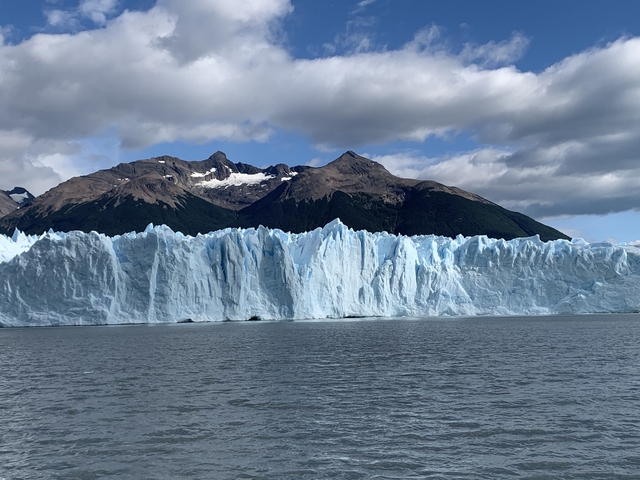Glacier with mountain backdrop.