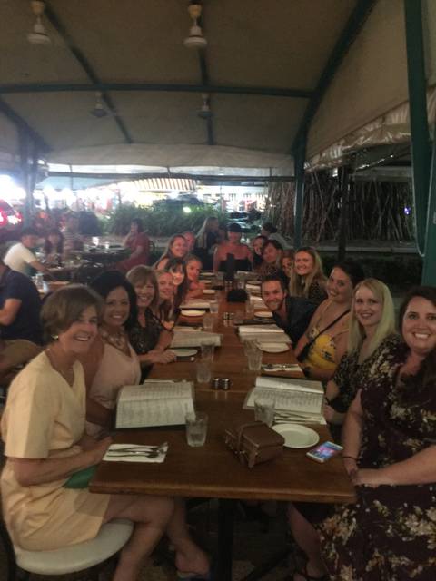       Group of people dining at a restaurant.
  