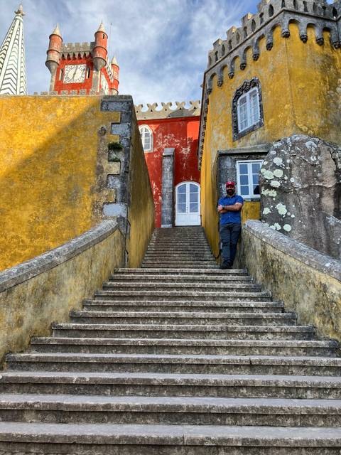A colorful building with a person standing on steps.