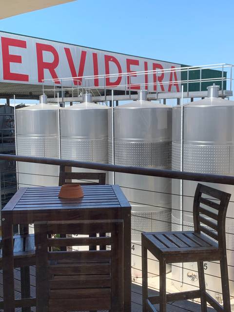       Exterior of a modern building seen from a patio.
  