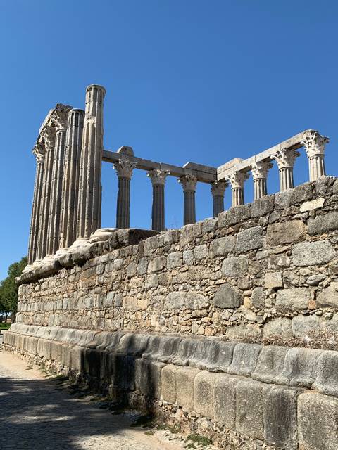       Ancient remains of a stone structure with columns.
  