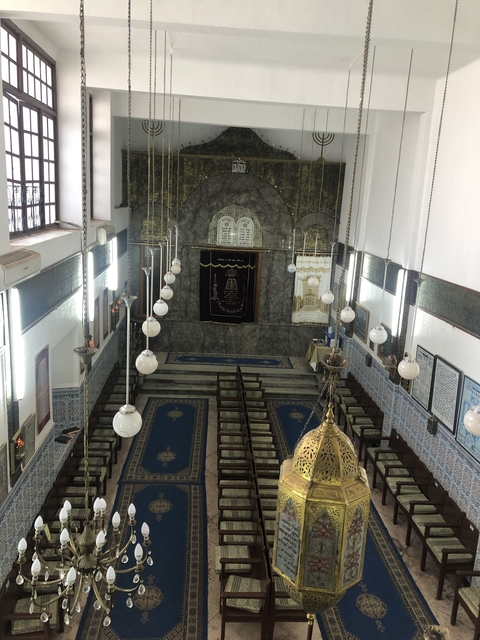 Interior view of a synagogue with chandeliers.
