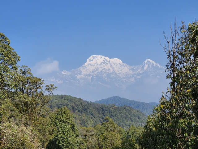       Scenic view of mountains covered with snow under a clear blue sky.
  