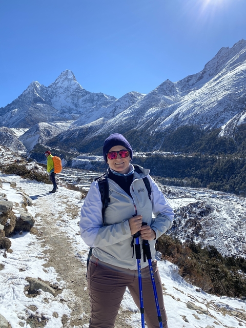Person in snowy mountainous landscape.