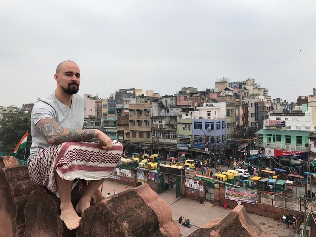       Person sitting with a cityscape view from above.
  
