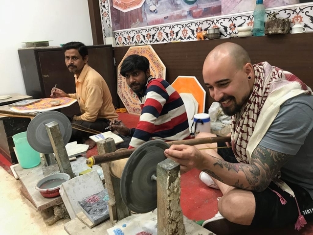       Men working on marble craftsmanship.
  