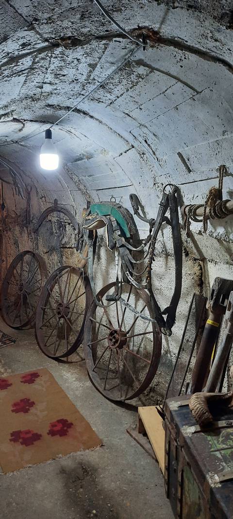       Vintage bicycle inside a stone-walled room.
  
