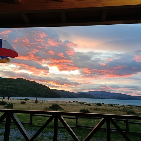 Vivid sunset over a lake with dramatic clouds.