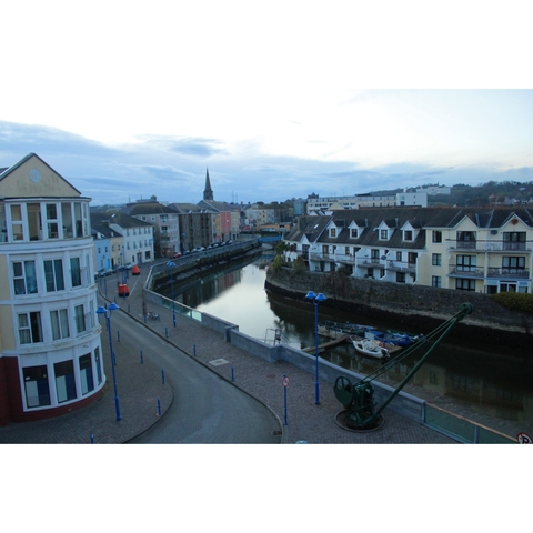Canal scene in a town with residential buildings lining the water.