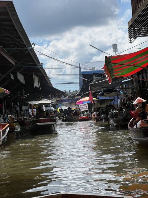 Boat-filled river view at a floating market.