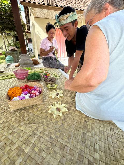       People engaging in a traditional crafting activity.
  