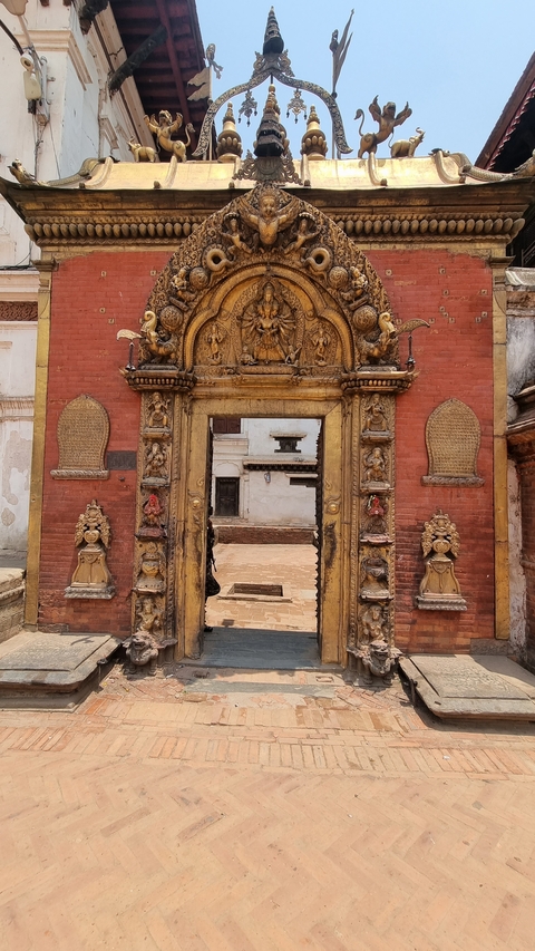       Ornate doorway with intricate carvings in a temple complex.
  