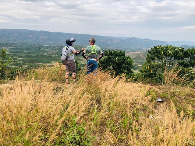Two people looking out over terraced landscape.