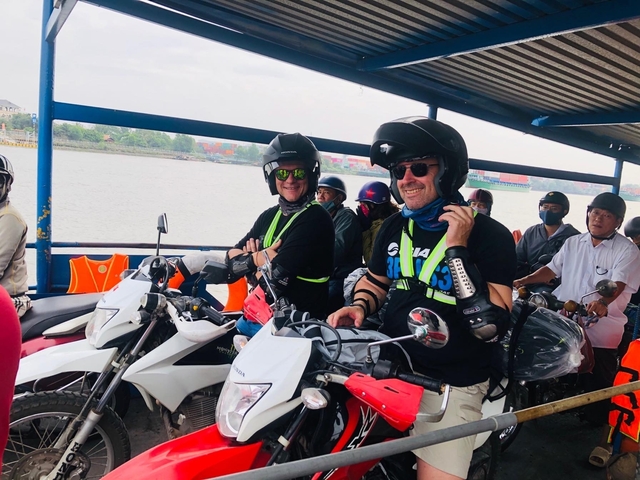 People with motorcycles on a ferry.
