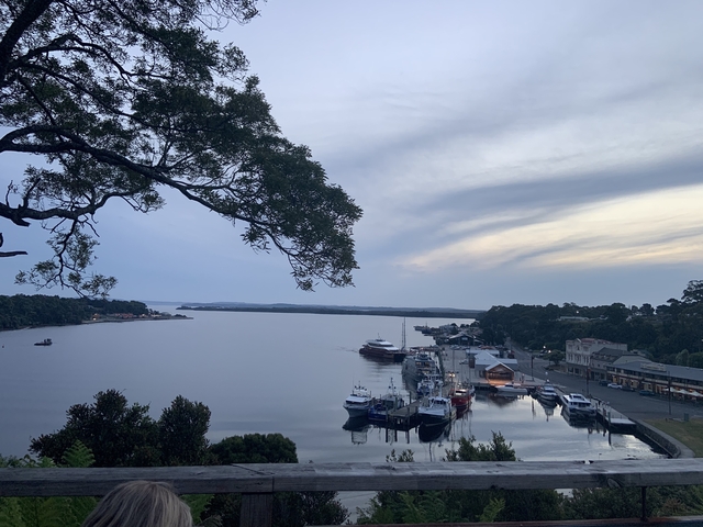 Harbor view with boats and a cloudy sky.
