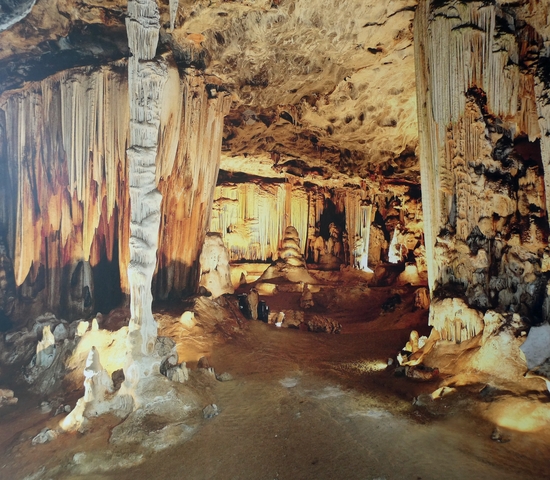Beautiful cave interior with dramatic stalactites and rock formations.