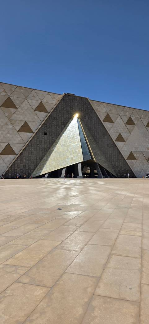 Modern architecture with a triangular focal point and paved surroundings.