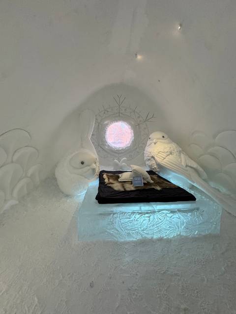 Intricate ice sculptures inside an ice hotel room.
