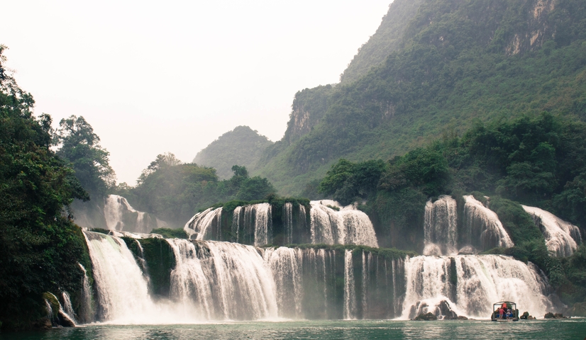       Lush waterfalls cascading down sheer cliffs.
  