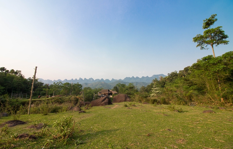       A landscape with rolling hills and a clear blue sky.
  