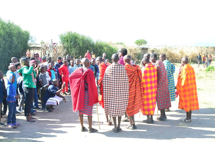 Group of people in traditional and modern clothes outdoors.