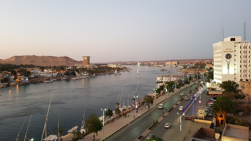 Cityscape with river and buildings at dusk.