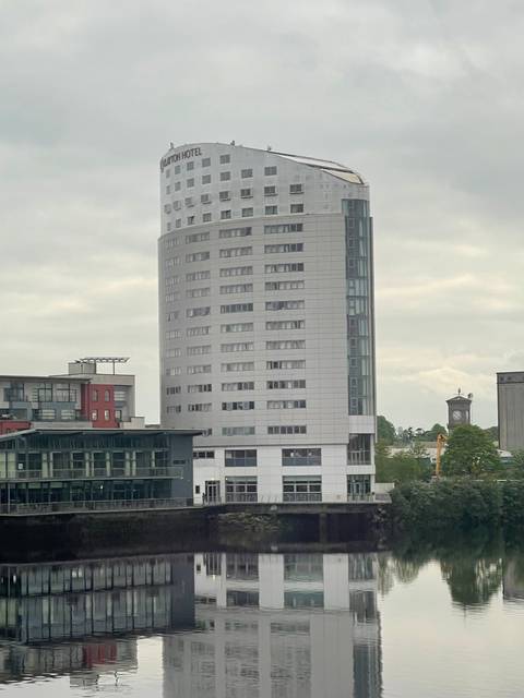 Tall hotel building by the river.