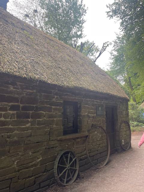Old stone house with thatched roof.