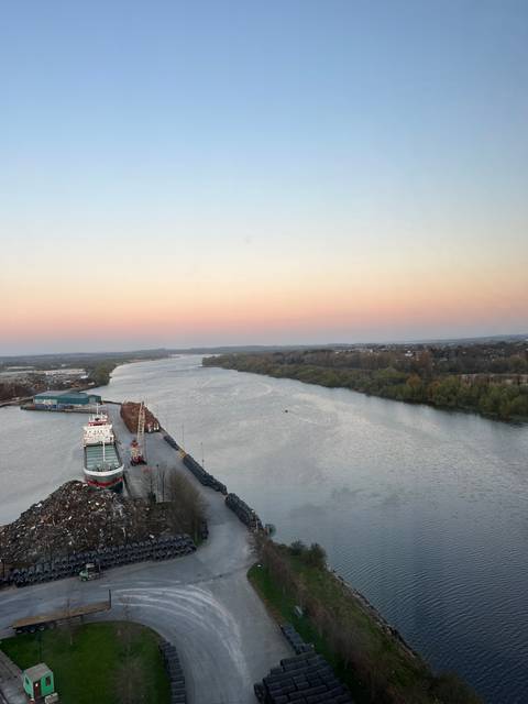 River with a bridge in the distance during sunset.