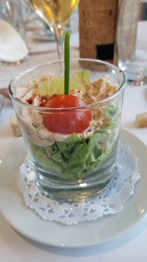 Gastronomic dish served in a glass with vegetables.