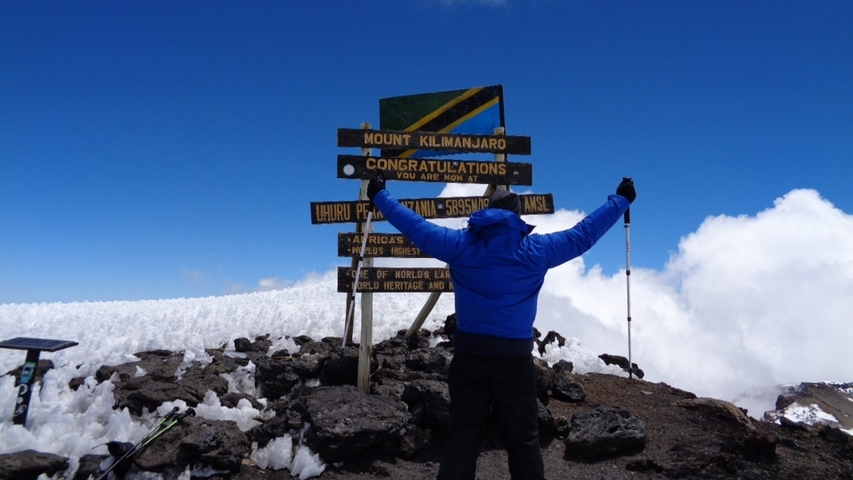       Person celebrating at Mount Kilimanjaro summit
  