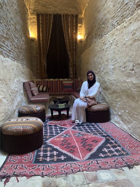       Person inside a room with traditional carpet decor.
  