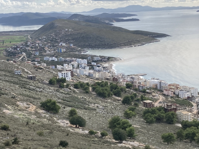 Coastal town with white buildings along the shore.