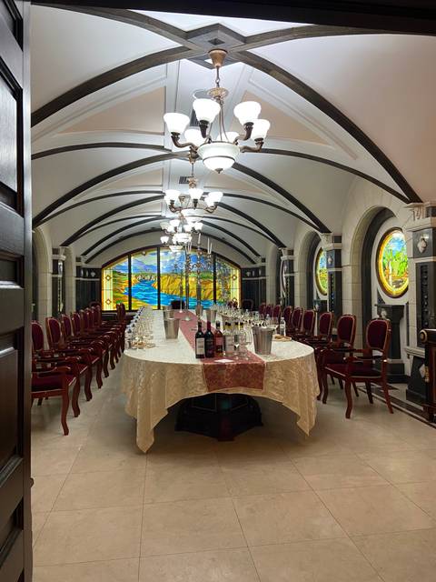       Interior with long table and decorative elements.
  