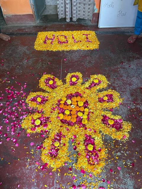       Flower arrangement on the ground for Holi celebration.
  