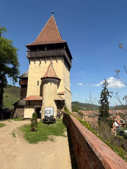 Historic fortified church against a clear sky.