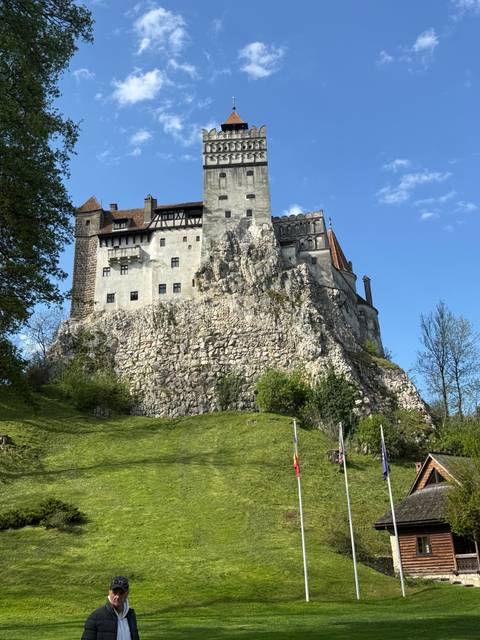 Bran Castle with lush green surroundings.
