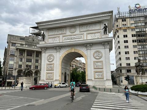      Large ornamental archway in an urban setting.
  