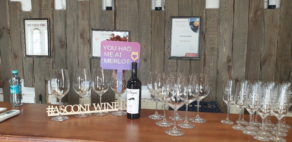       Table with wine glasses and a sign saying You Had Me At Merlot.
  