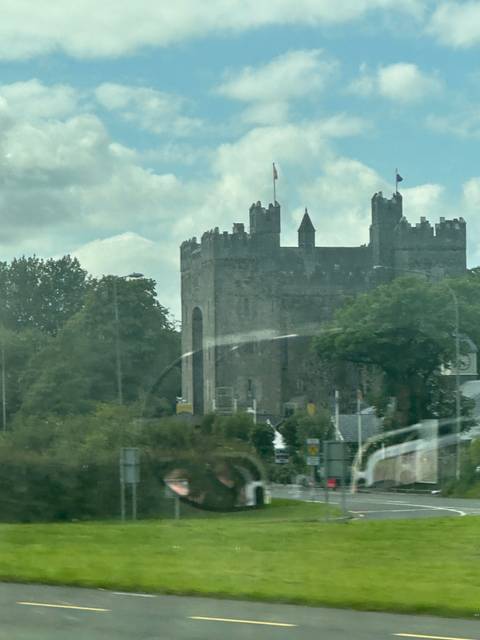 Castle-like building with turrets viewed from a distance.