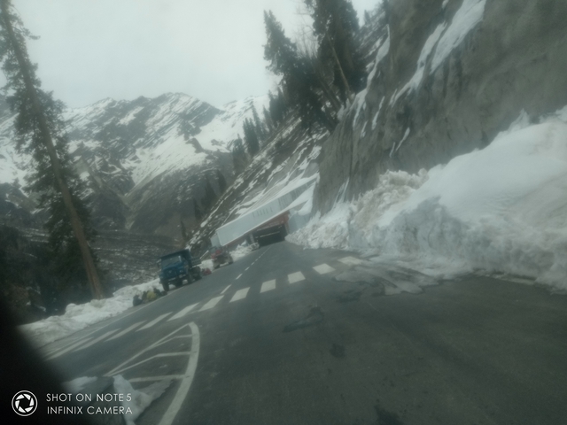 Blurry image of a snow-covered landscape with a tunnel entrance.