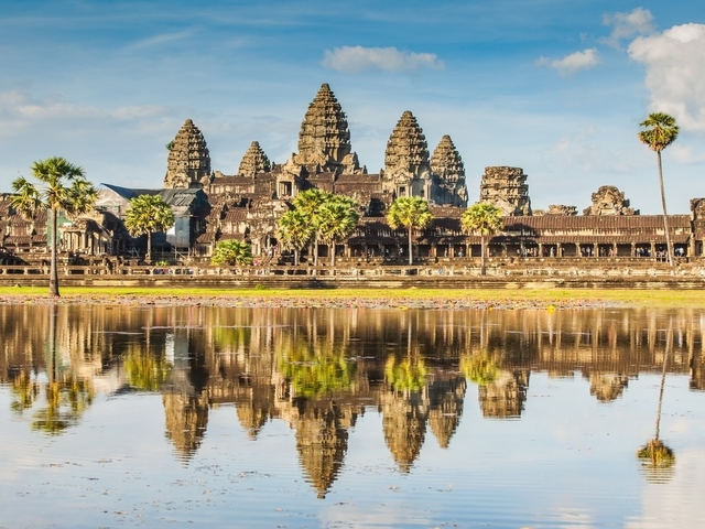 Angkor Wat temple complex with reflection in still water.