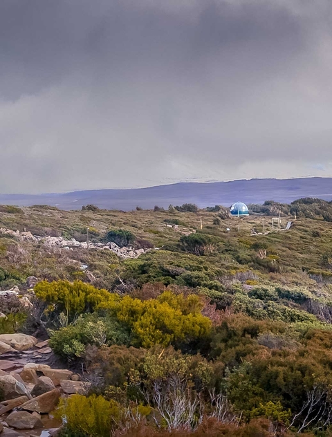 Dome-shaped structure on a barren landscape.
