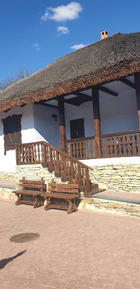       Traditional building with wooden railings and thatched roof.
  